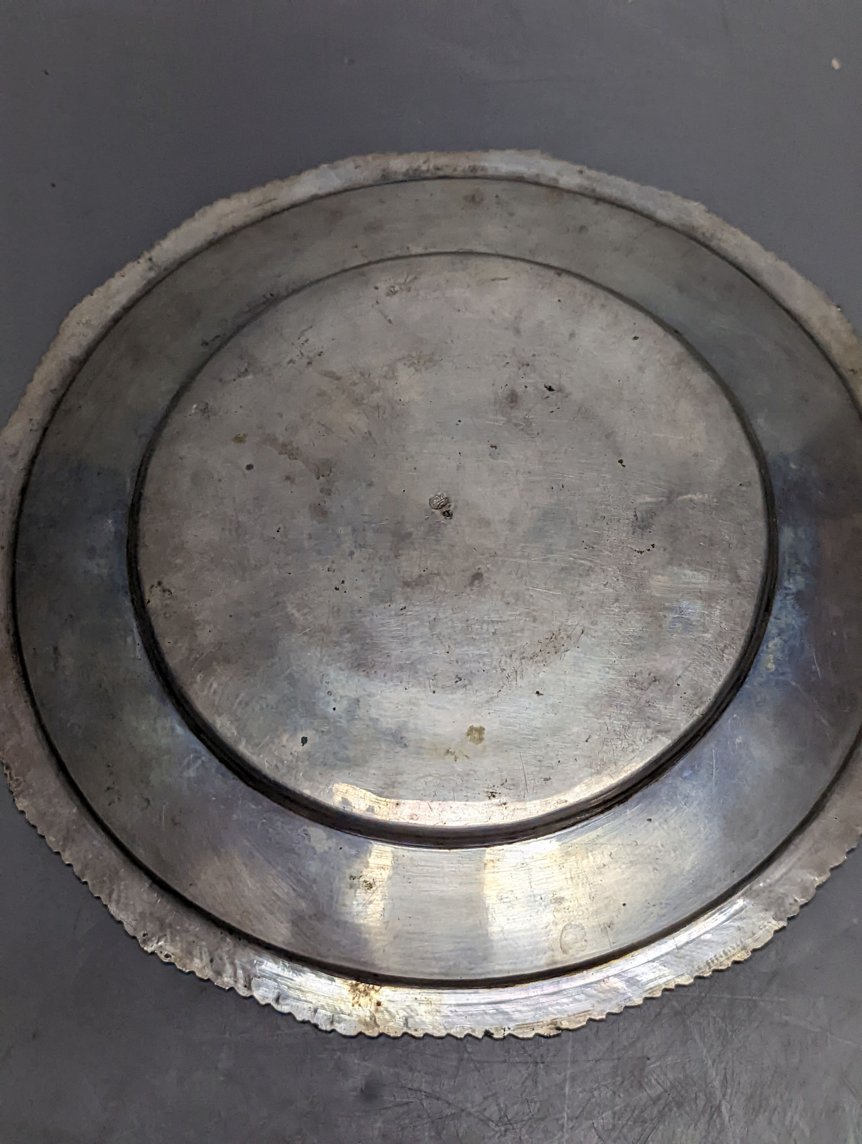 A Persian engraved white metal bowl, diameter 17.9cm and a similar stand or plate, 22cm, 20oz.